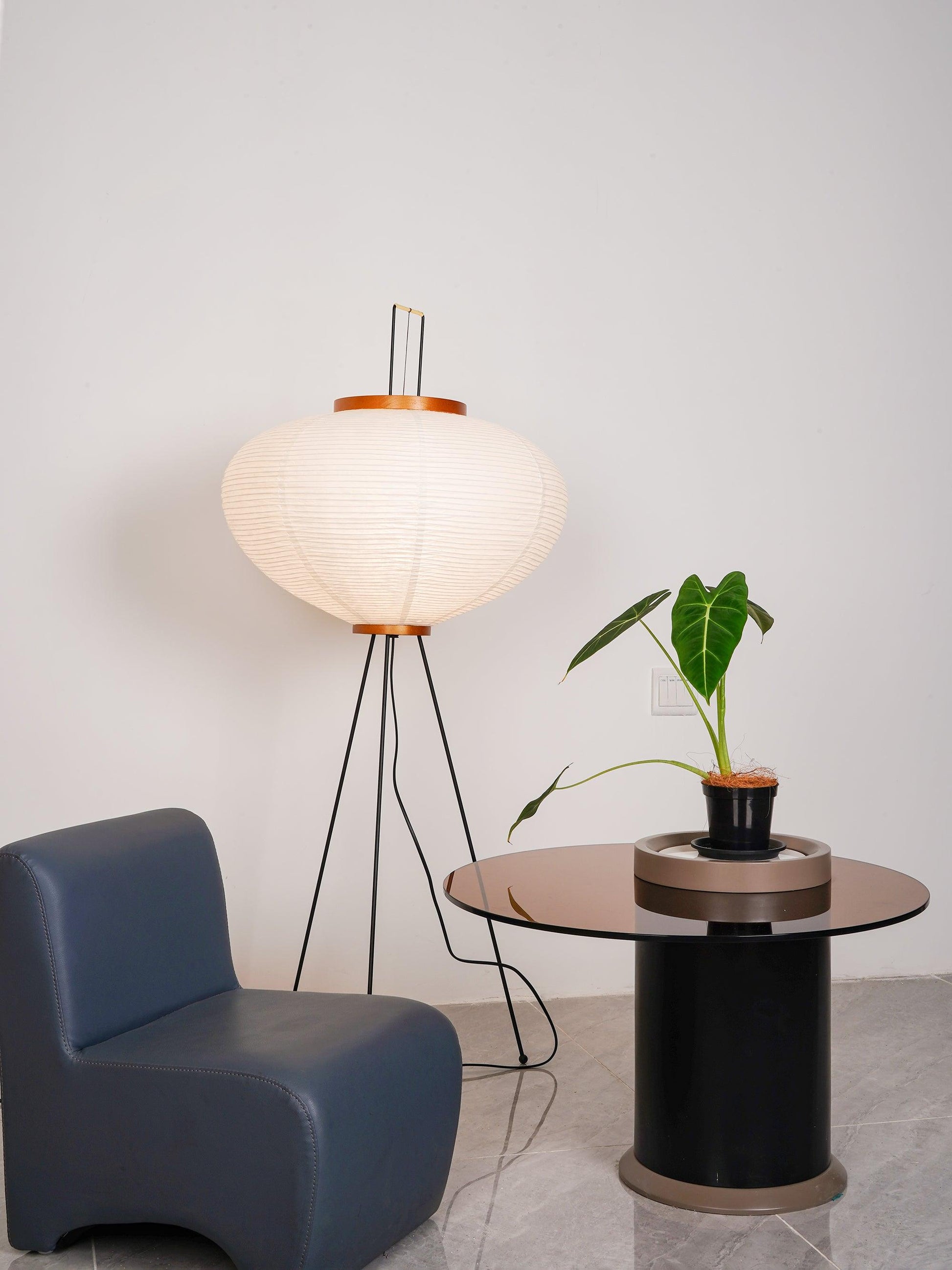 "Minimalist rice paper floor lamp with sleek metal frame and soft diffused light, perfect for creating a warm ambiance."