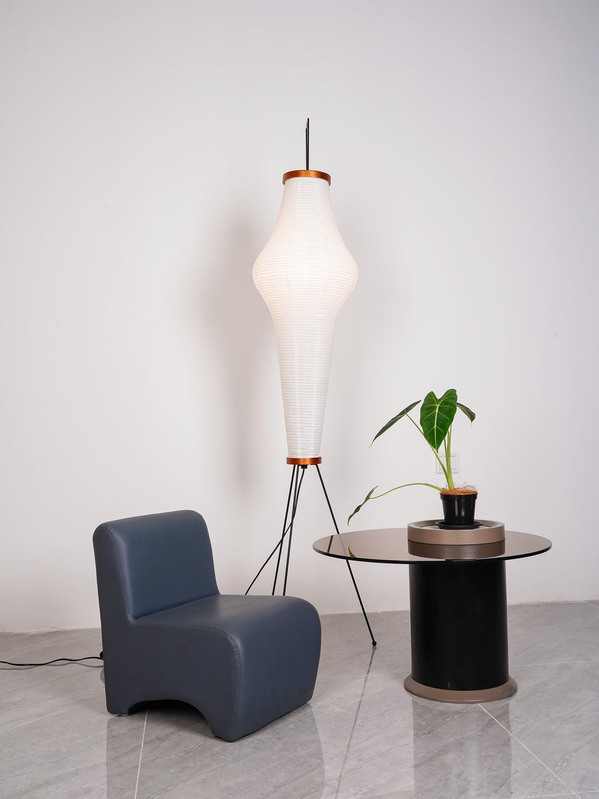 "Minimalist rice paper floor lamp with sleek metal frame and soft diffused light, perfect for creating a warm ambiance."