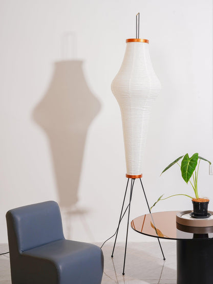 "Minimalist rice paper floor lamp with sleek metal frame and soft diffused light, perfect for creating a warm ambiance."