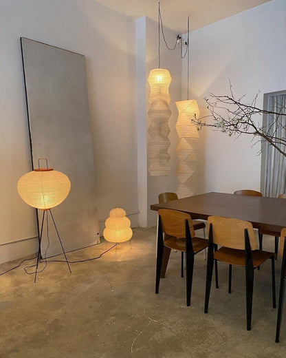 "Minimalist rice paper floor lamp with sleek metal frame and soft diffused light, perfect for creating a warm ambiance."
