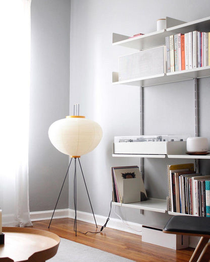 "Minimalist rice paper floor lamp with sleek metal frame and soft diffused light, perfect for creating a warm ambiance."