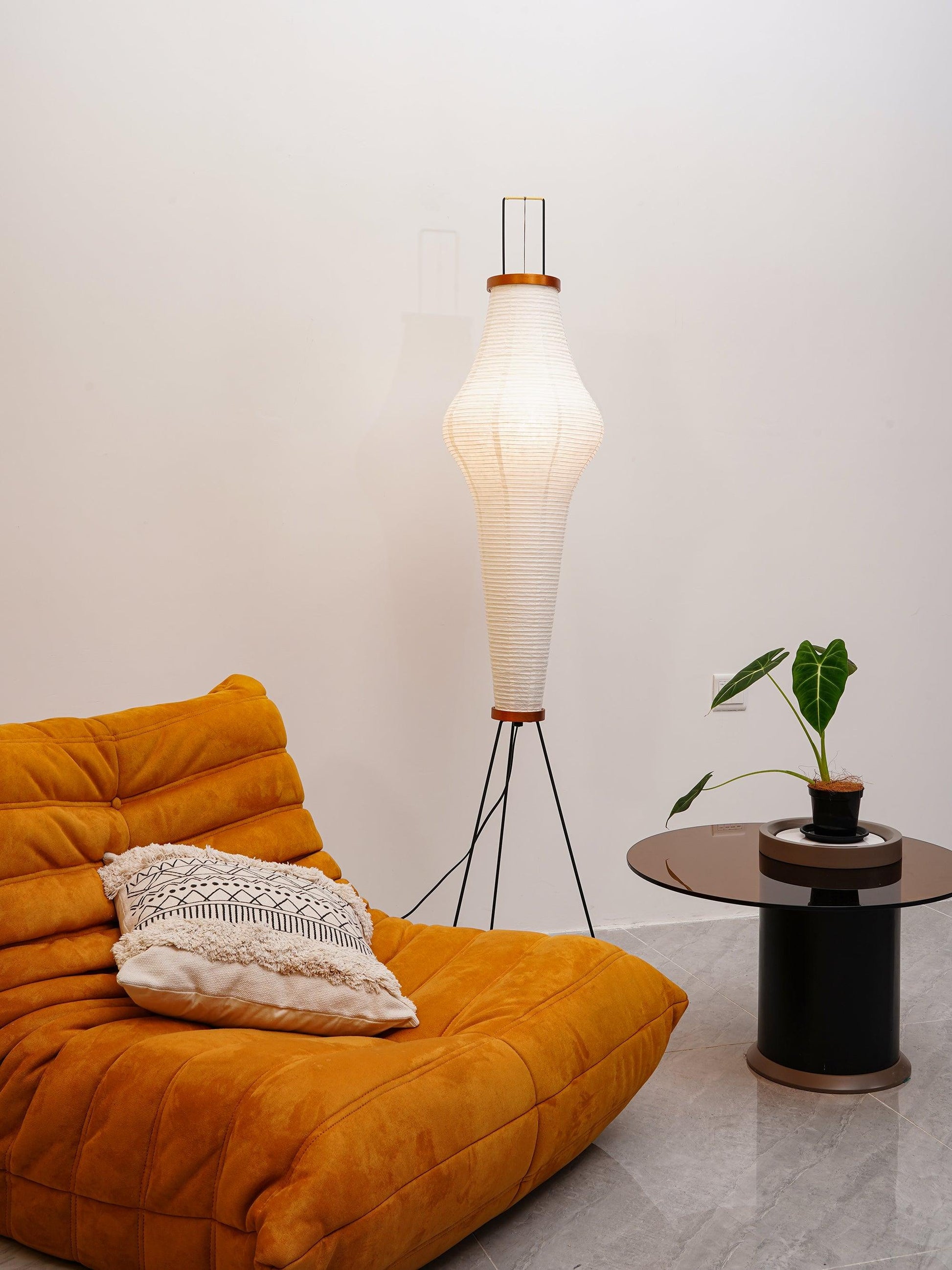 "Minimalist rice paper floor lamp with sleek metal frame and soft diffused light, perfect for creating a warm ambiance."