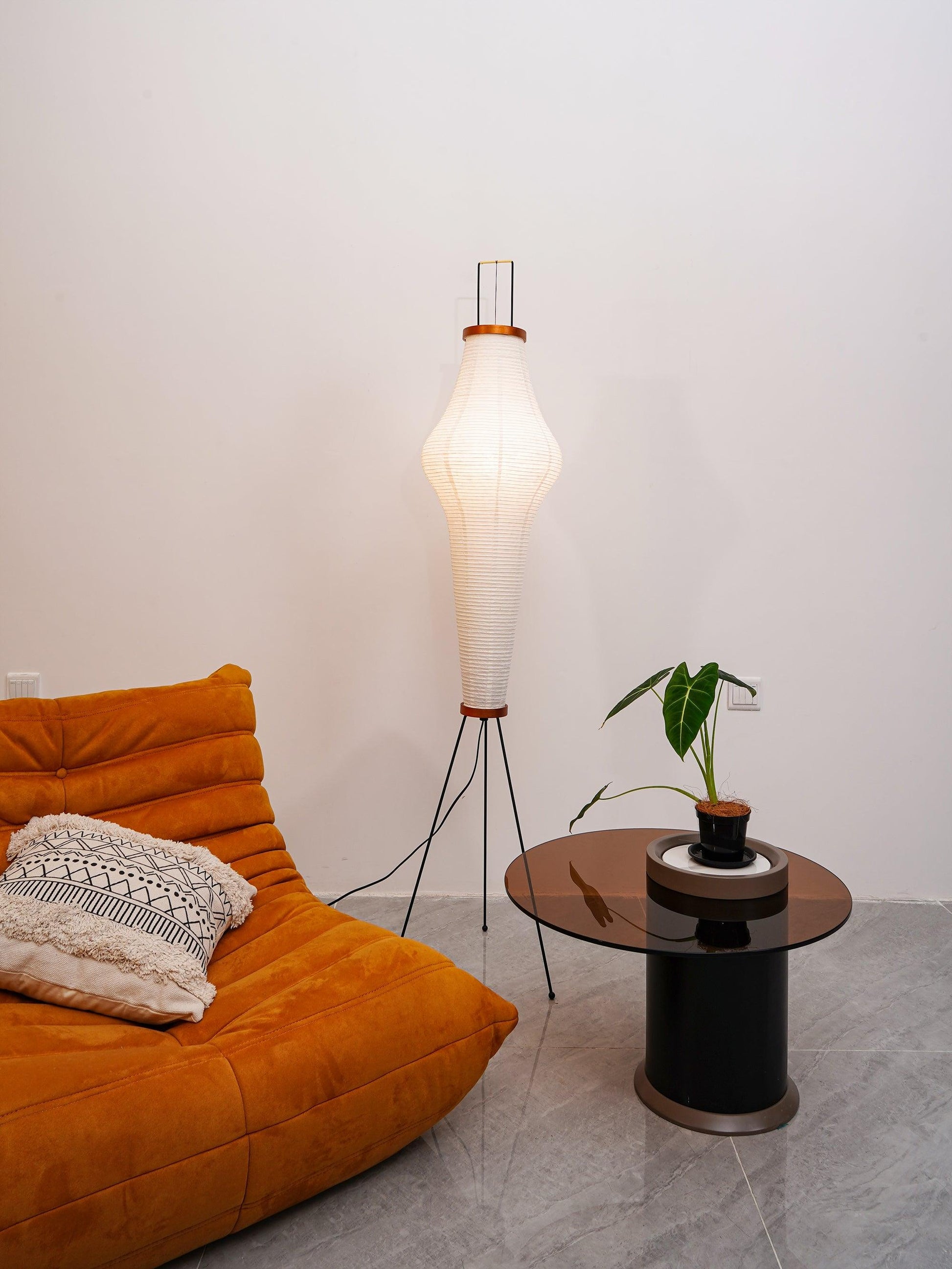 "Minimalist rice paper floor lamp with sleek metal frame and soft diffused light, perfect for creating a warm ambiance."
