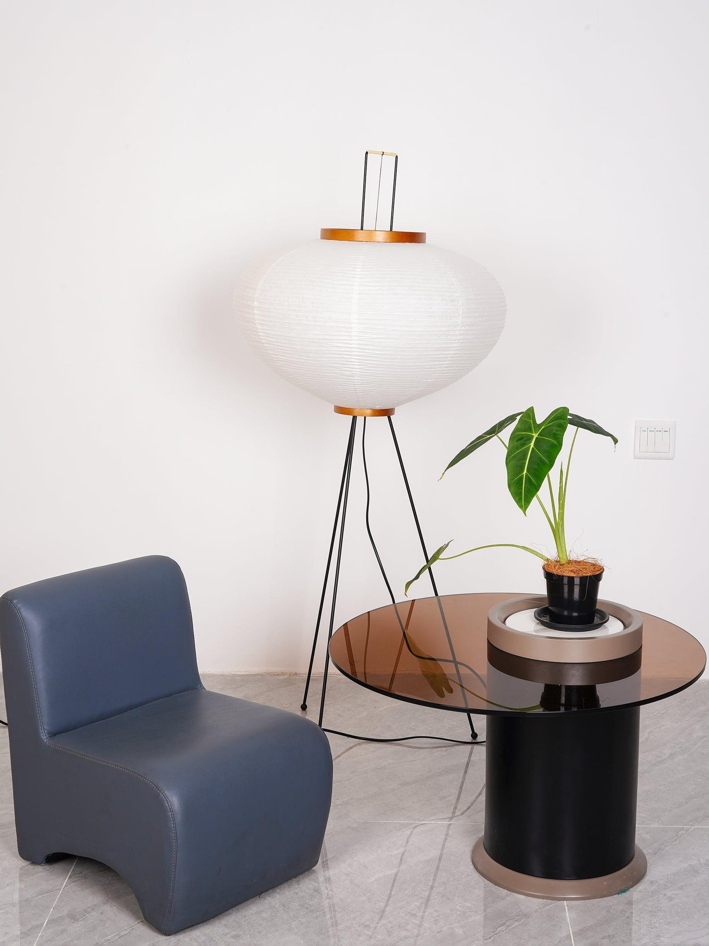 "Minimalist rice paper floor lamp with sleek metal frame and soft diffused light, perfect for creating a warm ambiance."