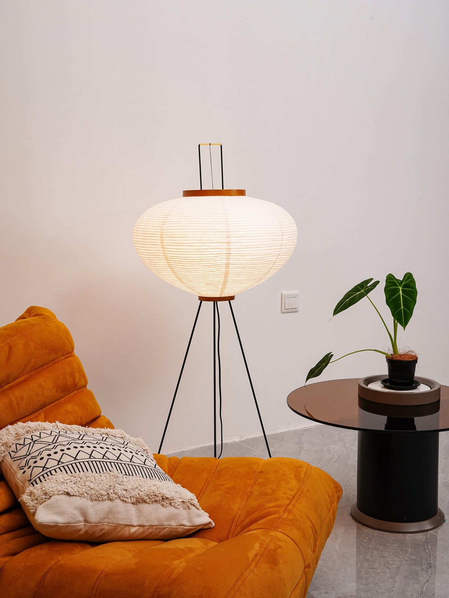 "Minimalist rice paper floor lamp with sleek metal frame and soft diffused light, perfect for creating a warm ambiance."