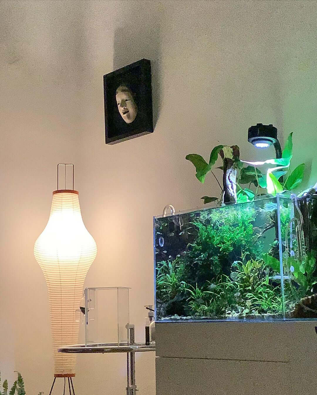 "Minimalist rice paper floor lamp with sleek metal frame and soft diffused light, perfect for creating a warm ambiance."