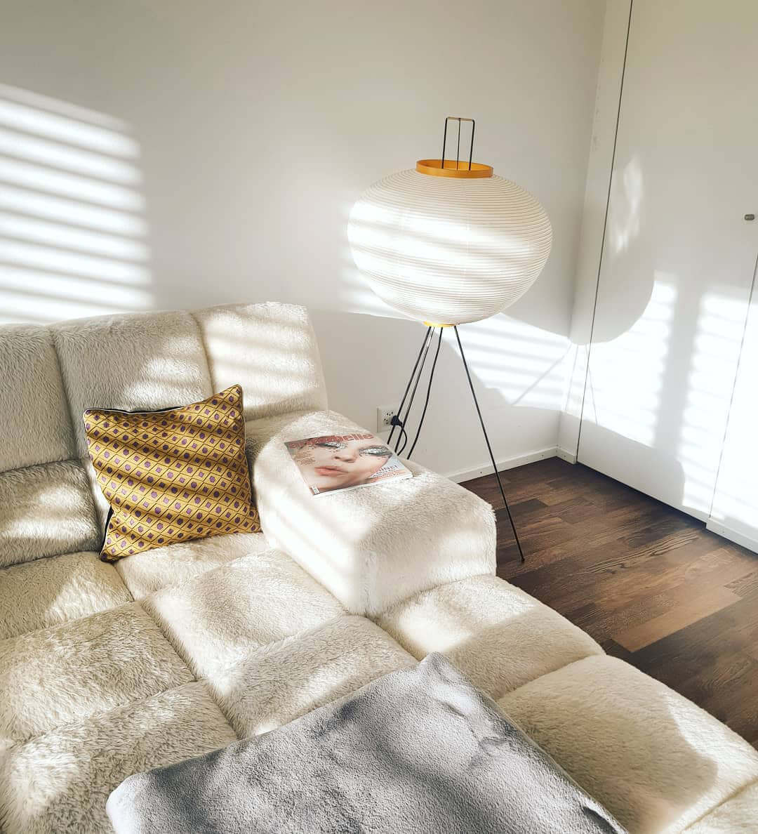 "Minimalist rice paper floor lamp with sleek metal frame and soft diffused light, perfect for creating a warm ambiance."