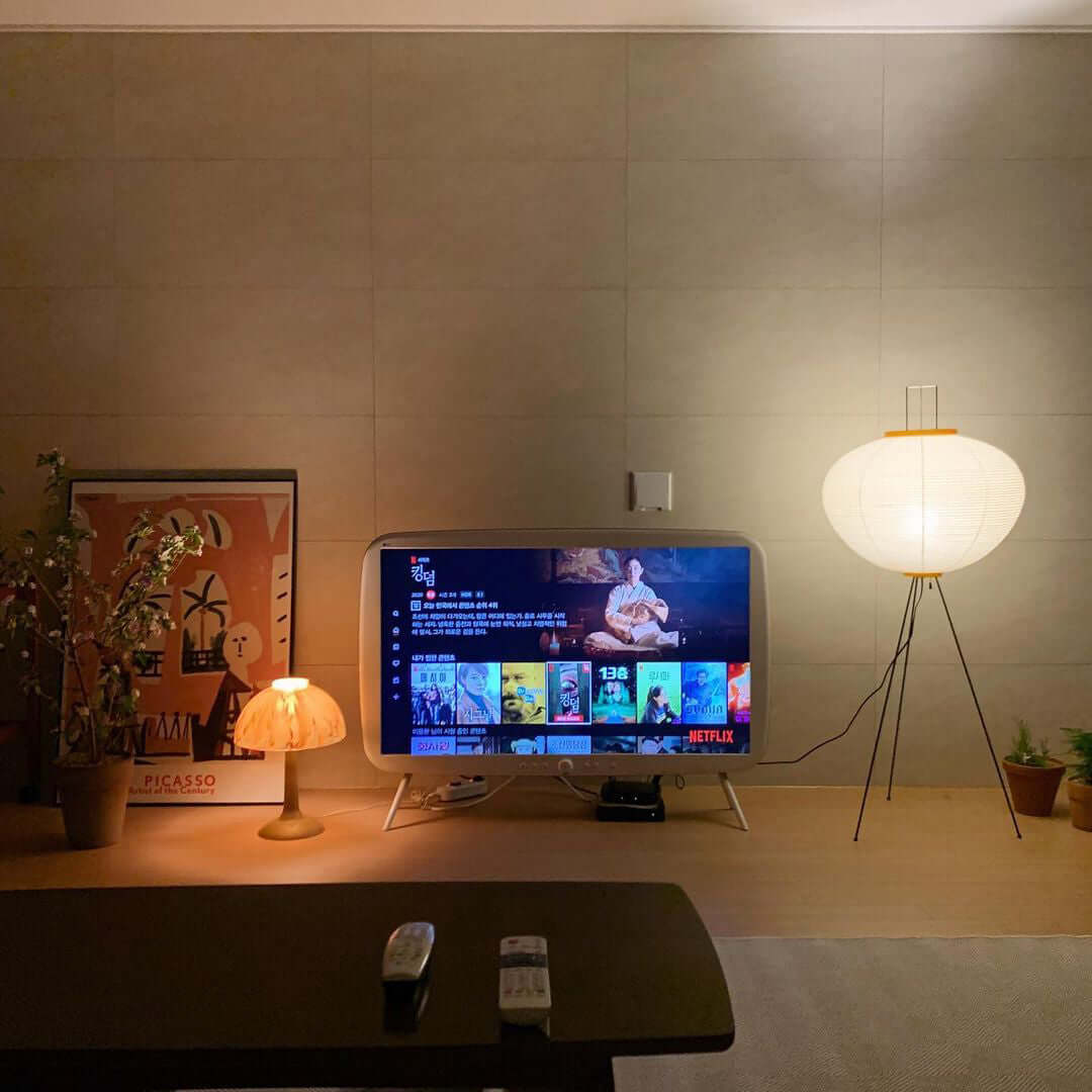 "Minimalist rice paper floor lamp with sleek metal frame and soft diffused light, perfect for creating a warm ambiance."