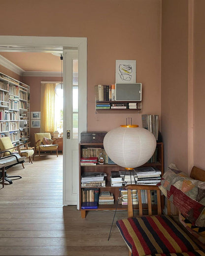 "Minimalist rice paper floor lamp with sleek metal frame and soft diffused light, perfect for creating a warm ambiance."