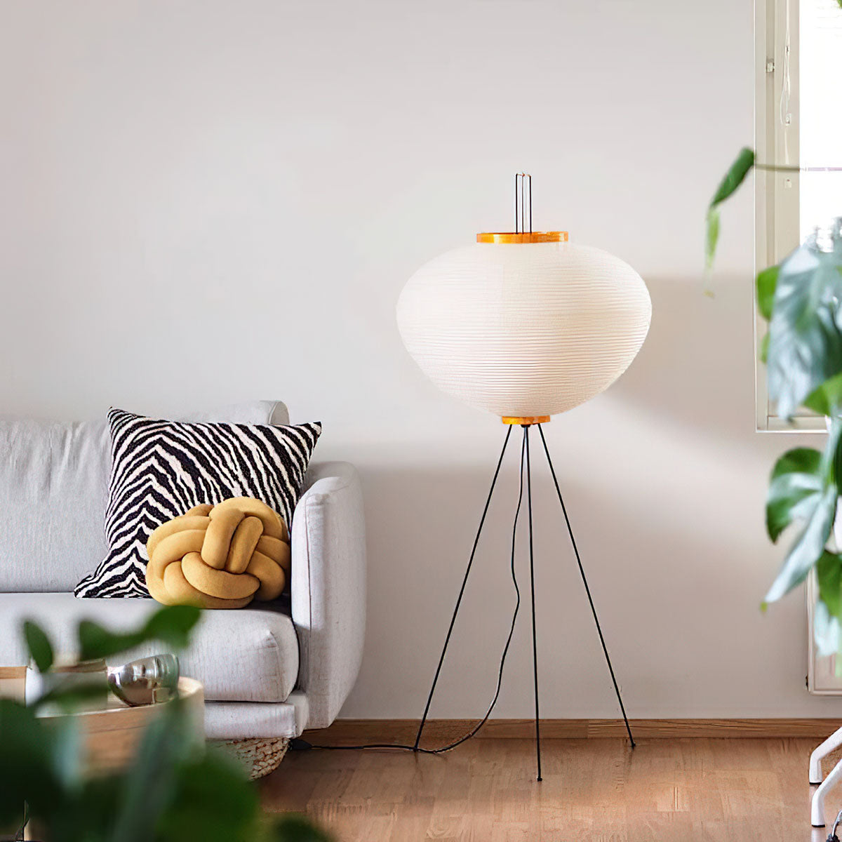 "Minimalist rice paper floor lamp with sleek metal frame and soft diffused light, perfect for creating a warm ambiance."