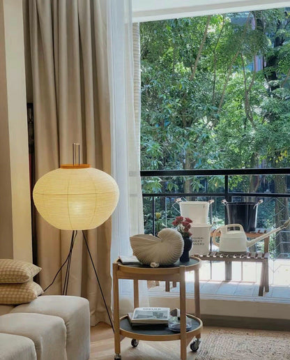 "Minimalist rice paper floor lamp with sleek metal frame and soft diffused light, perfect for creating a warm ambiance."