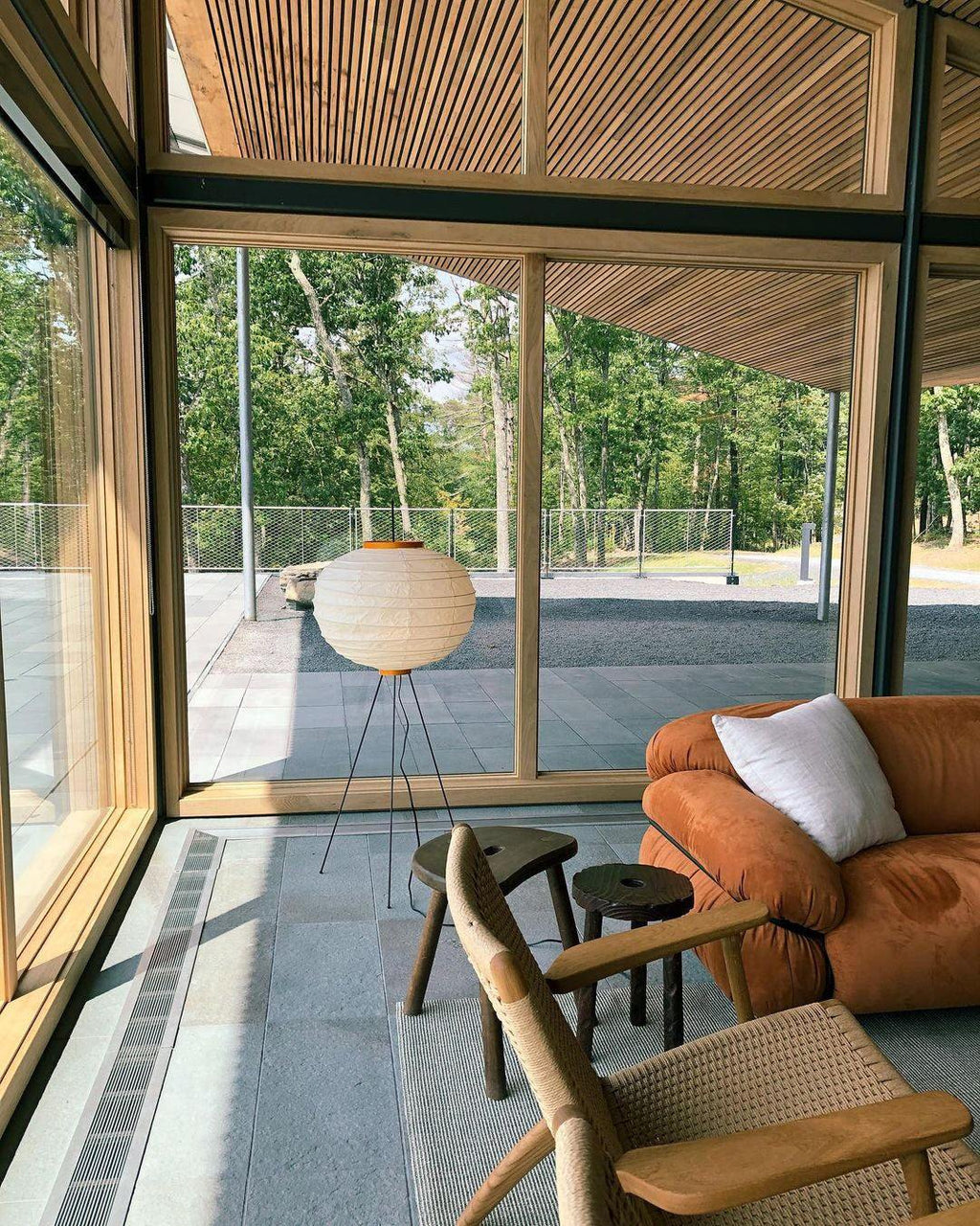 "Minimalist rice paper floor lamp with sleek metal frame and soft diffused light, perfect for creating a warm ambiance."