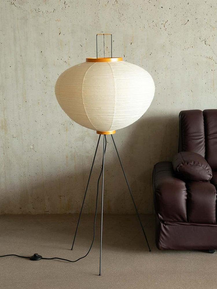 "Minimalist rice paper floor lamp with sleek metal frame and soft diffused light, perfect for creating a warm ambiance."