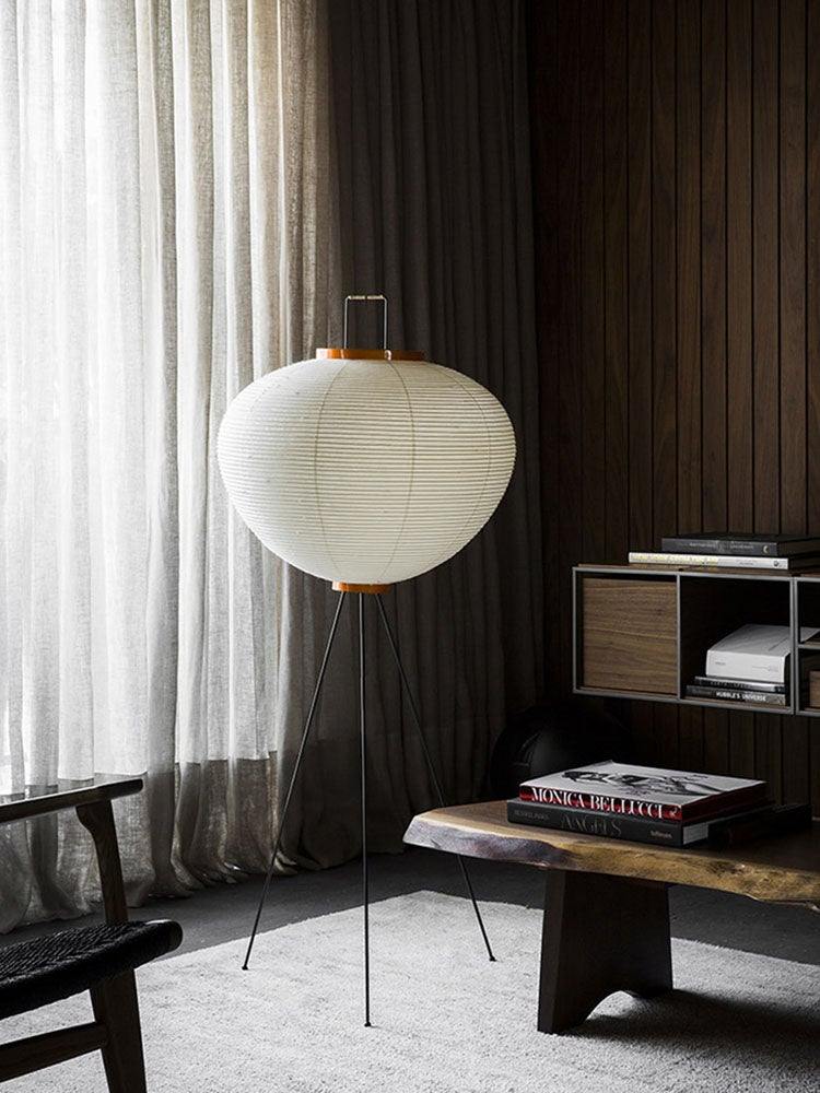 "Minimalist rice paper floor lamp with sleek metal frame and soft diffused light, perfect for creating a warm ambiance."