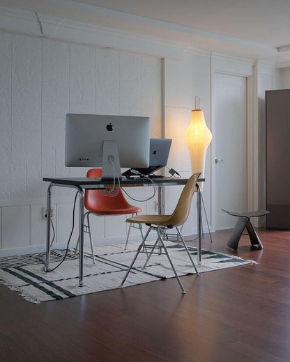 "Minimalist rice paper floor lamp with sleek metal frame and soft diffused light, perfect for creating a warm ambiance."