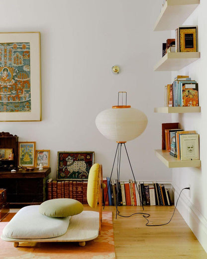 "Minimalist rice paper floor lamp with sleek metal frame and soft diffused light, perfect for creating a warm ambiance."