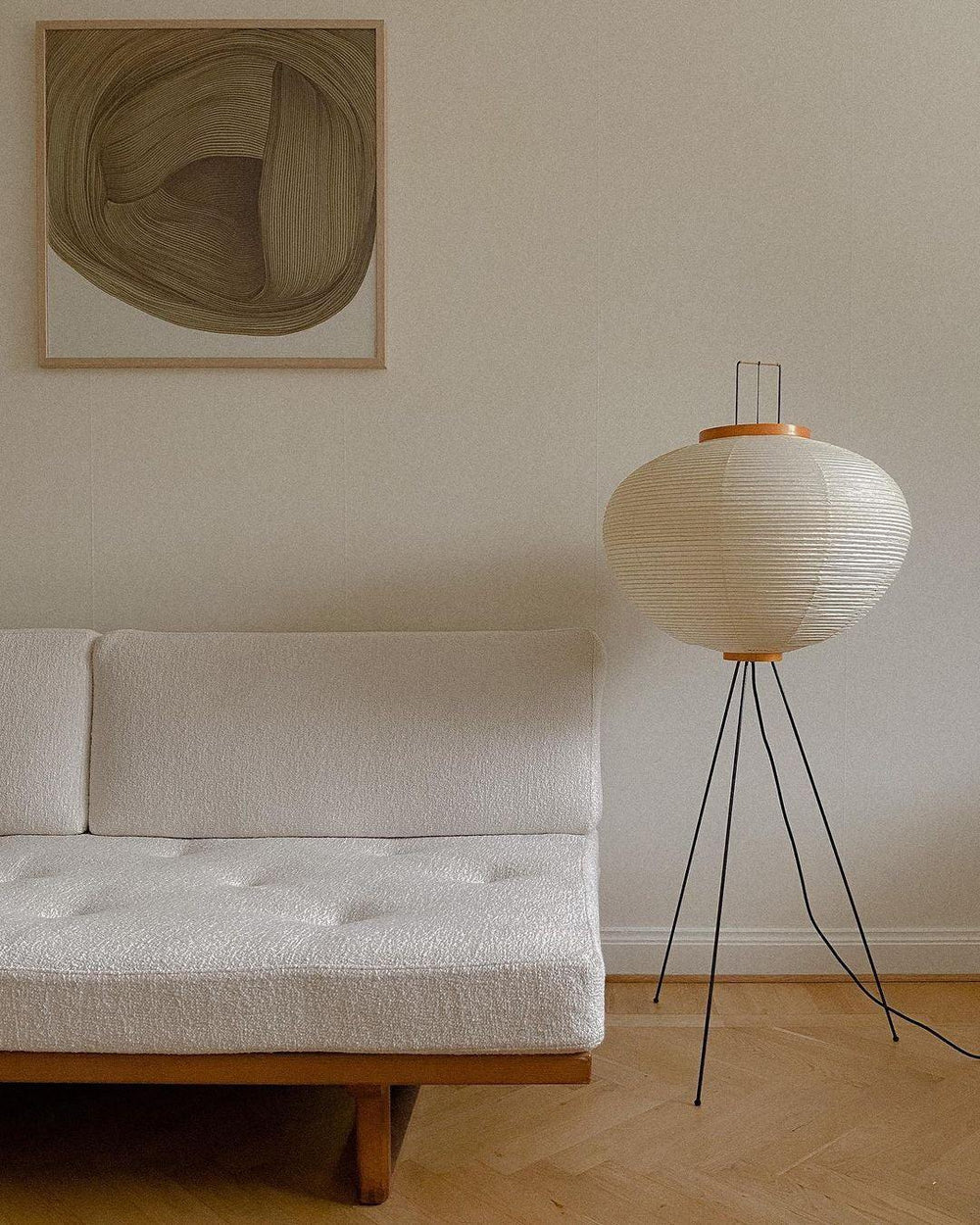"Minimalist rice paper floor lamp with sleek metal frame and soft diffused light, perfect for creating a warm ambiance."