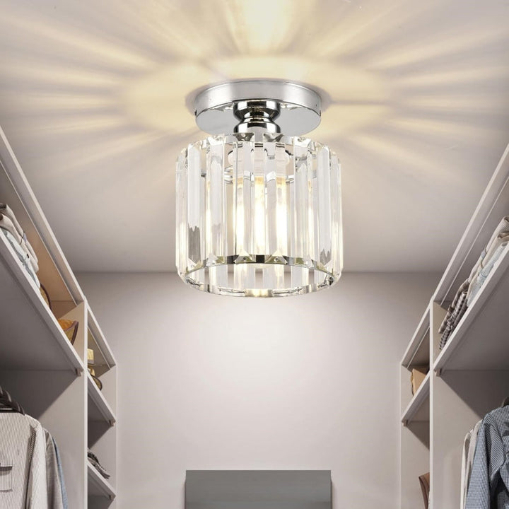 Modern black crystal flush mount ceiling light, sleek brass fixture, crystal shade, ideal for rooms with low ceilings.