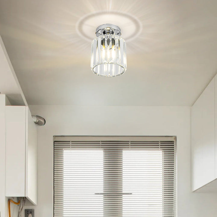Modern black crystal flush mount ceiling light, sleek brass fixture, crystal shade, ideal for rooms with low ceilings.