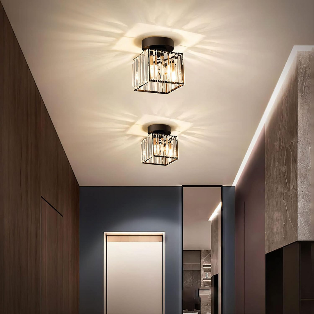 Modern black crystal flush mount ceiling light, sleek brass fixture, crystal shade, ideal for rooms with low ceilings.