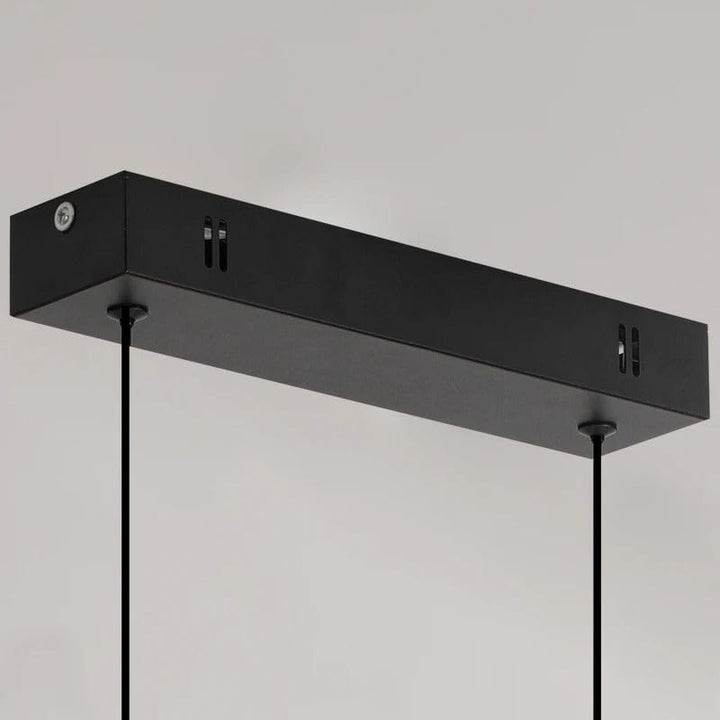 "Modern black pendant light with tubular silhouette, minimalist aluminium fixture, perfect for dining rooms and kitchens."