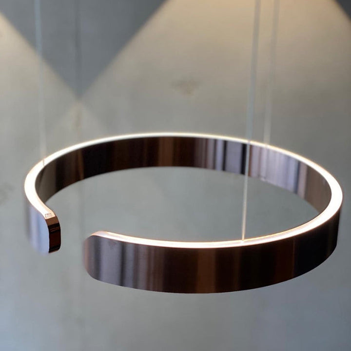 "Modern circular LED pendant light in minimal design, black finish, ideal for elegant home interiors and efficient lighting."