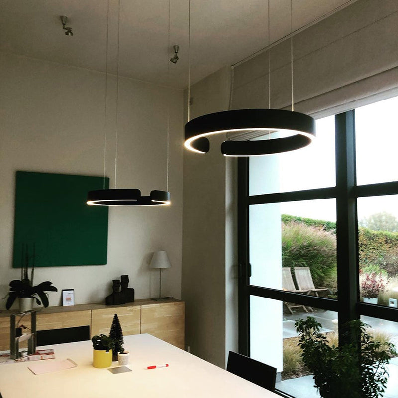 "Modern circular LED pendant light in minimal design, black finish, ideal for elegant home interiors and efficient lighting."