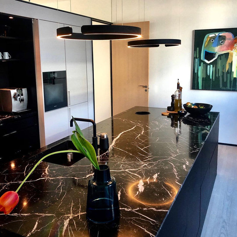 "Modern circular LED pendant light in minimal design, black finish, ideal for elegant home interiors and efficient lighting."