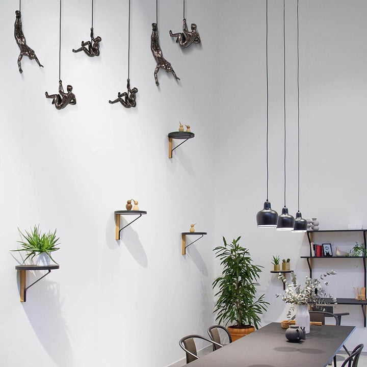 Dynamic climber art sculpture. Modern wall decor for living rooms, adding artistic flair.