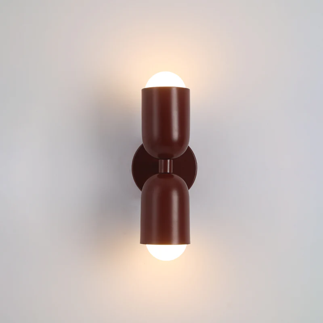 Sleek dual-sided LED wall lamp. A modern interior lamp providing vibrant home decor accent lighting.