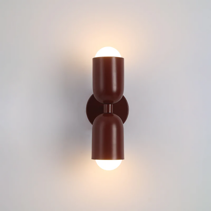 Sleek dual-sided LED wall lamp. A modern interior lamp providing vibrant home decor accent lighting.