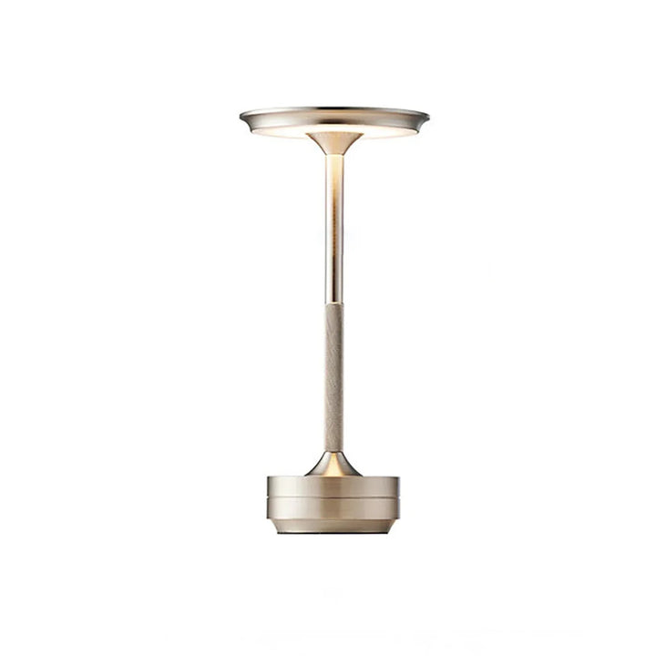 Modern cordless table lamp with touch control, Nordic design, gold frame, brushed finish, illuminating a stylish room.