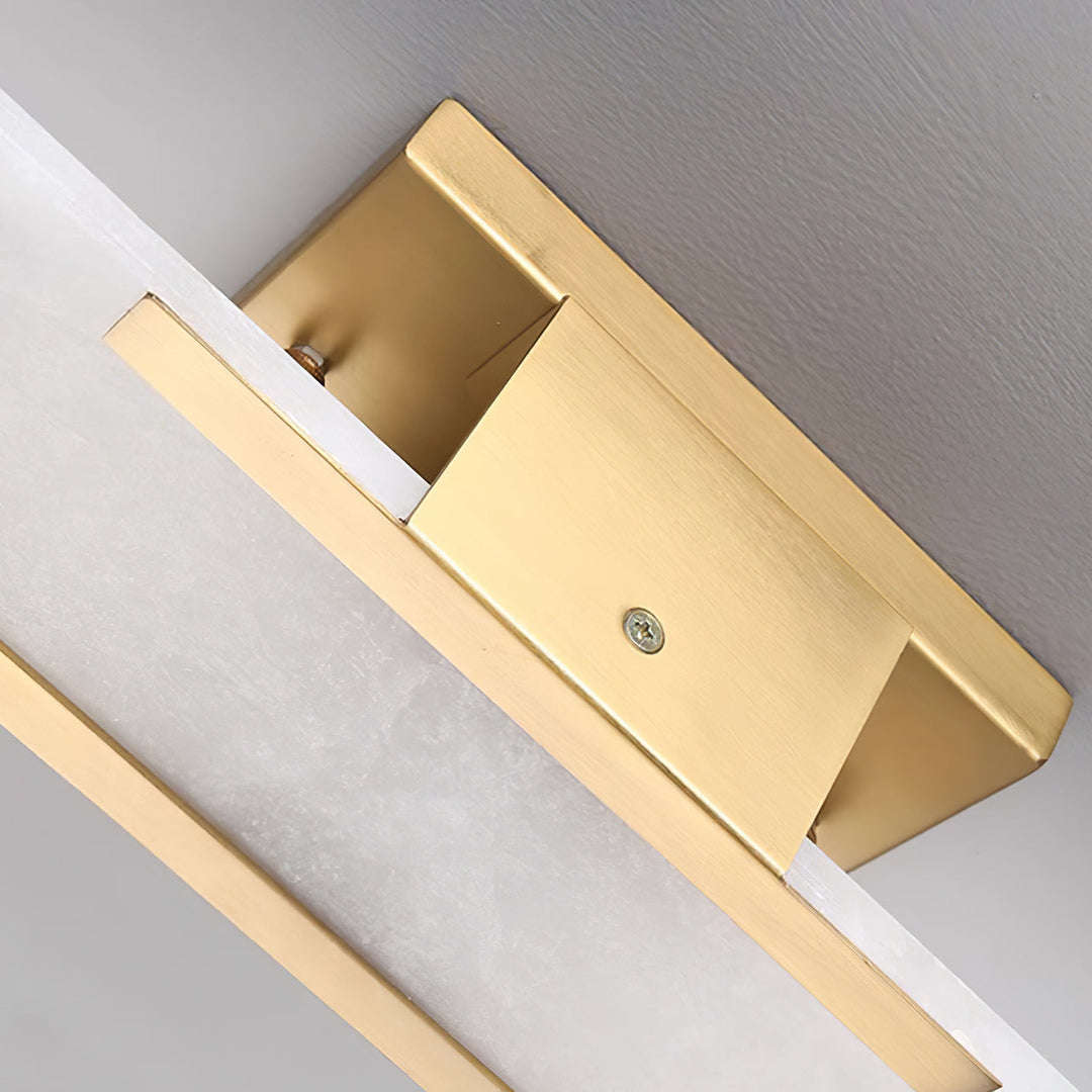 "Modern elongated alabaster wall lamp with metal and brass accents, emits warm glow, suitable for chic interior decor."