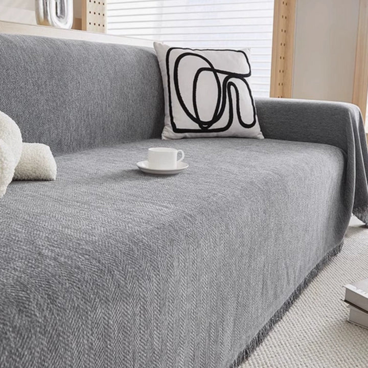 Easy-care, pet-friendly modern throw blanket protects furniture, ideal for minimalist living rooms.