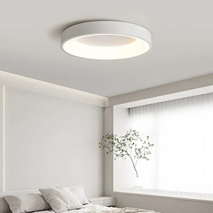 "Modern Nordic LED ceiling light with sleek round design in black, white, and gray for stylish minimalistic home decor."