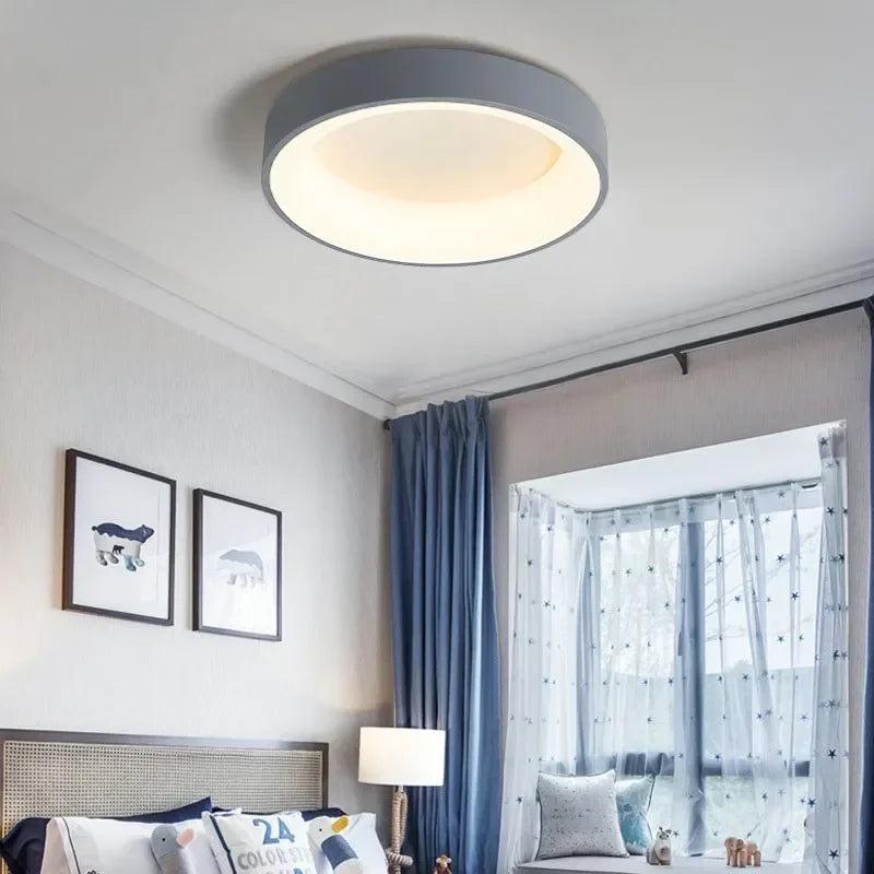 "Modern Nordic LED ceiling light with sleek round design in black, white, and gray for stylish minimalistic home decor."