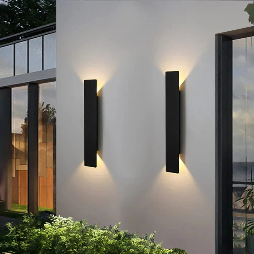 Modern outdoor LED wall light, black or white finish, IP65 waterproof, up/down lighting, enhances exterior decor.
