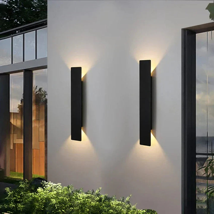 Modern outdoor LED wall light, black or white finish, IP65 waterproof, up/down lighting, enhances exterior decor.