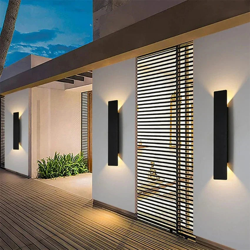 Modern outdoor LED wall light, black or white finish, IP65 waterproof, up/down lighting, enhances exterior decor.