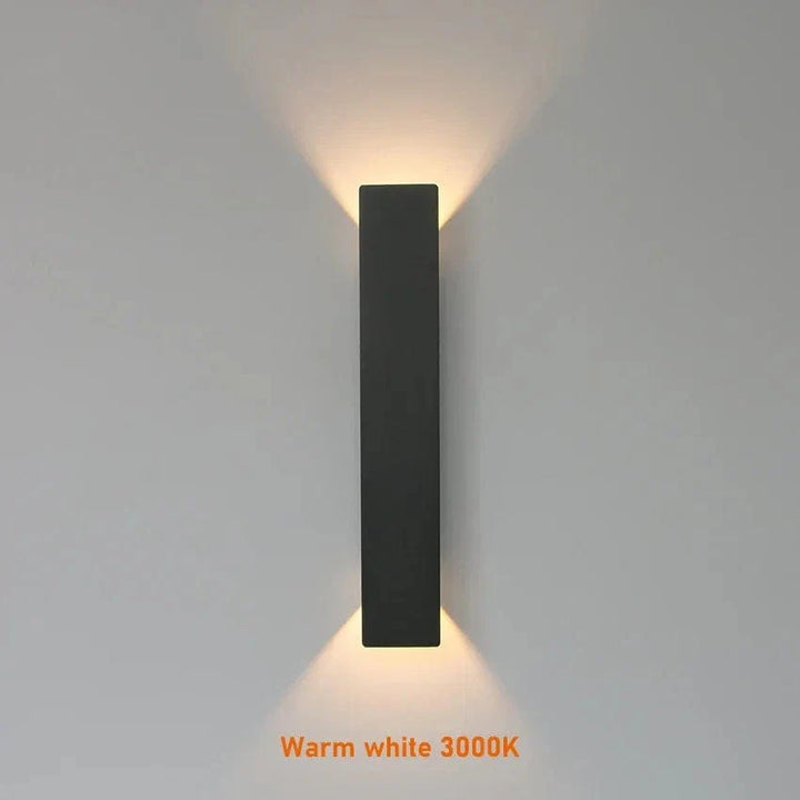 Modern outdoor LED wall light, black or white finish, IP65 waterproof, up/down lighting, enhances exterior decor.