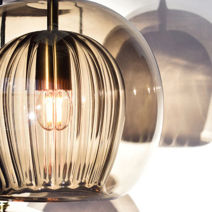 Sleek Aurora Sphere LED pendant lamp, perfect for modern dining rooms. Adjustable height.