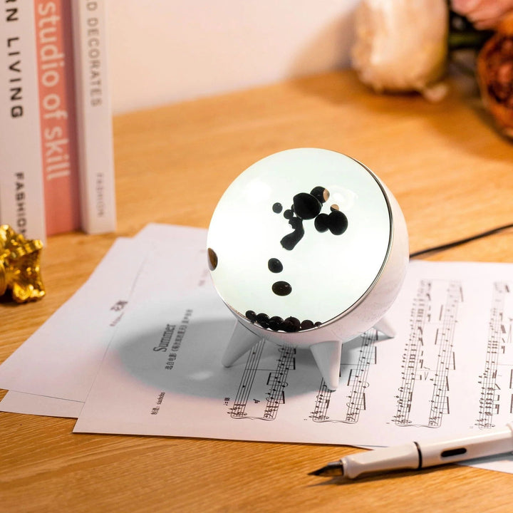 "Music-reactive ferrofluid display with black fluid art in motion, Bluetooth connectivity, and built-in lighting for tech lov