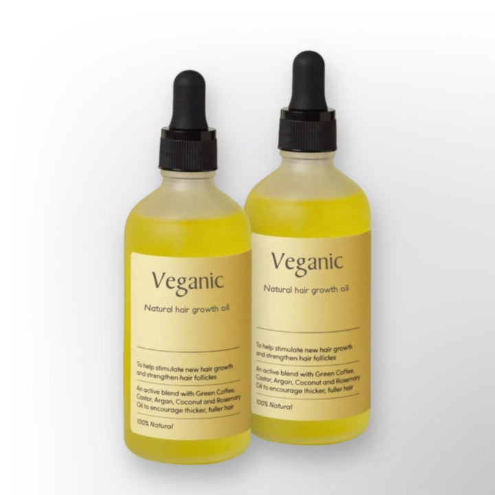 Natural Hair Growth Oil bottle, rich amber color, promises thicker hair with its 100% natural plant-based formulation.