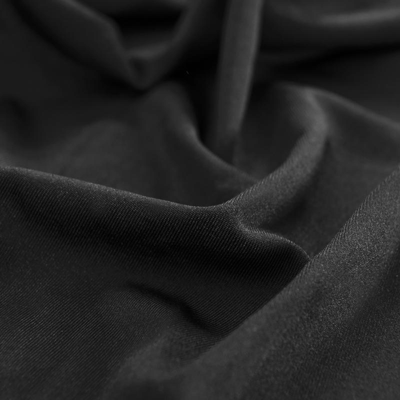 "Noir stretchable sofa cover in solid color, showcasing sleek fit and elegant style for versatile home decoration."