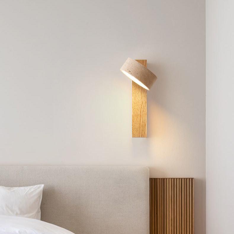 "Off-white travertine wall lamp with LED light, minimalist design, wood accents, ideal for ambient bedroom lighting."