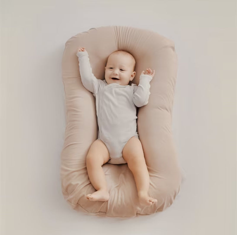 Orthopedic baby cushion in pink, supportive ergonomic design for healthy sleep, prevents flat head syndrome, soft material.