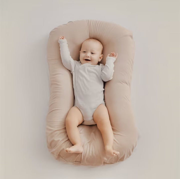 Orthopedic baby cushion in pink, supportive ergonomic design for healthy sleep, prevents flat head syndrome, soft material.