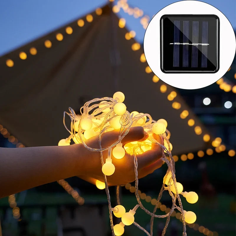 Outdoor solar festoon string lights with warm LED bulbs, perfect for garden, patio, or balcony eco-friendly decor.