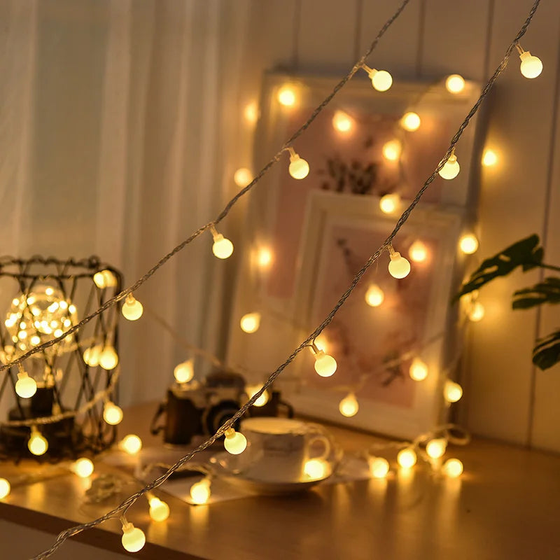 Solar festoon string lights draped across a garden pergola in daytime, charging for evening LED glow.