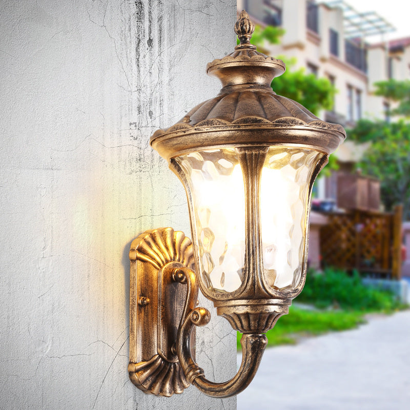 "Outdoor waterproof bronze wall light with clear water glass shade, elegant design for stylish exterior lighting."